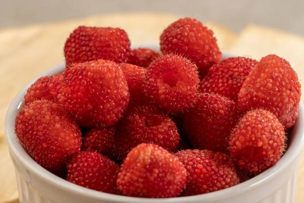 istock White ceramic bowl filled with fresh ripe raspberries on a wooden table top 1481700517