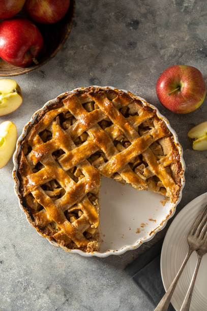 istock Whole apple pie, homemade fresh fruit pie with red apples. Top view 1481702719