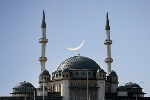 A crescent moon is above a mosque in the city of istanbul. Taksim Mosque,Istanbul