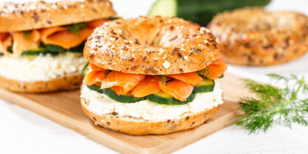 istock Bagel sandwich with salmon and cream cheese for breakfast on a kitchen board panorama 1481706956