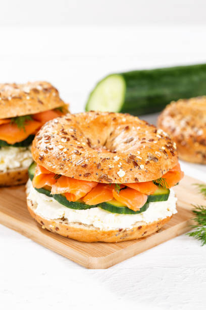 istock Bagel sandwich with salmon and cream cheese for breakfast on a kitchen board portrait format 1481707993