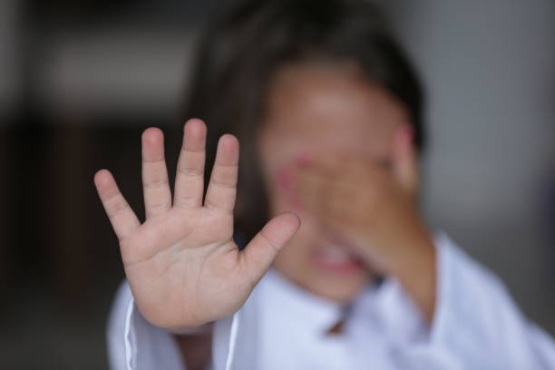 istock Child with hand on face signaling stop with other hand. 1481709405