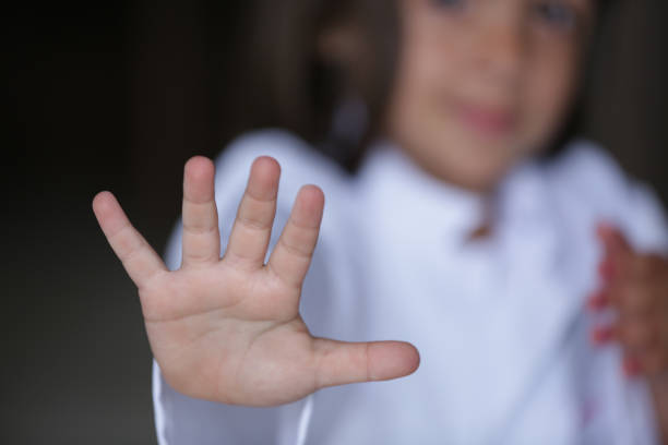 istock Child with hand on face signaling stop with other hand. 1481709411