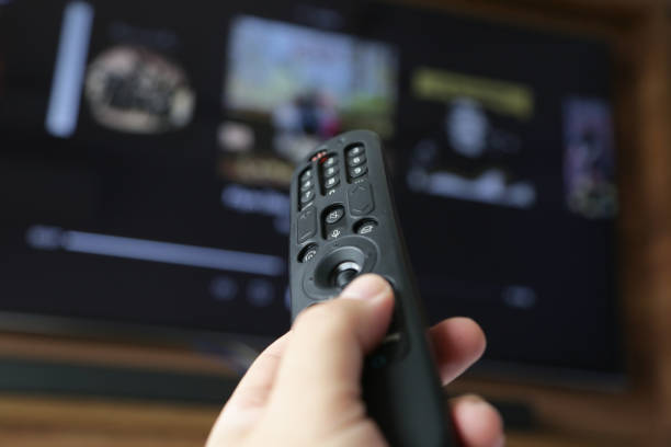 istock TV control in one's hand pointed to open the Streaming channel. 1481709677