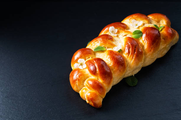 Food concept bread braided Challah Bread on black background with copy space