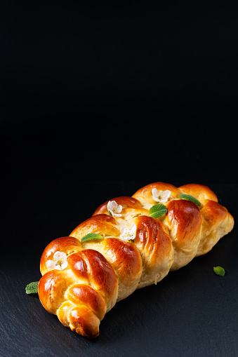 Food concept bread braided Challah Bread on black background with copy space