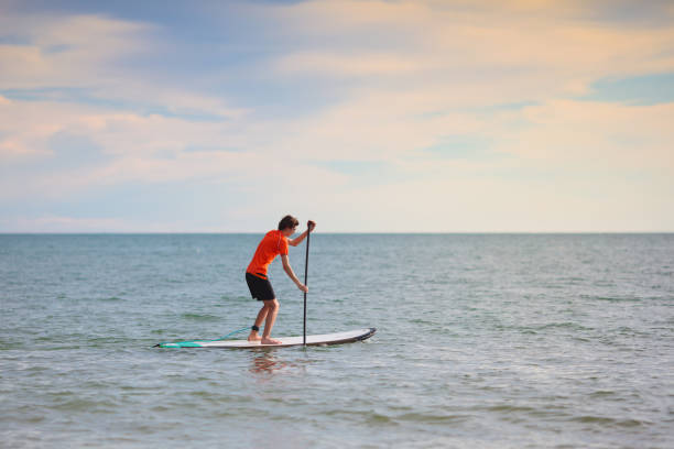 istock Man on stand up paddle. Water and beach sport 1481711931