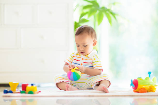istock Baby boy playing with toy 1481712905