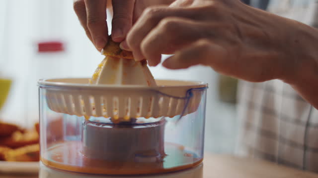 Senior woman making orange juice