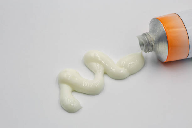 istock White paste squeezed out of a tube closeup on white 1481716860