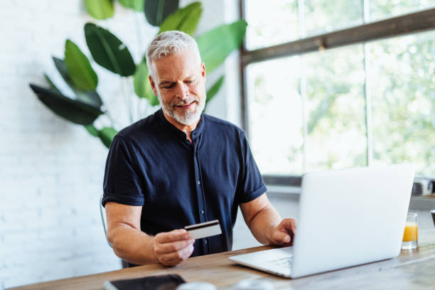 istock Senior man using credit card for online payments and banking 1481719060