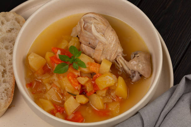 istock Roast chicken legs with vegetables with broth 1481719633
