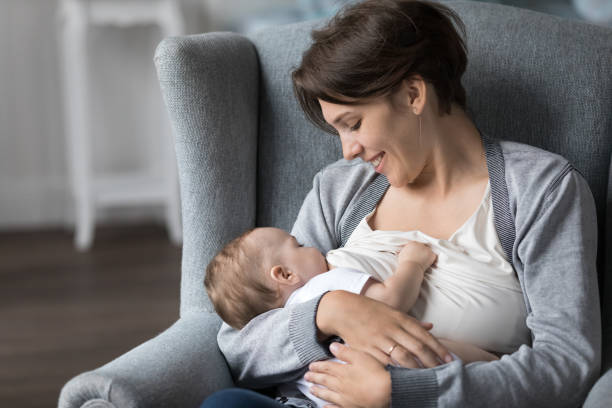 istock Happy young mother feeding baby mild from breast 1481721790