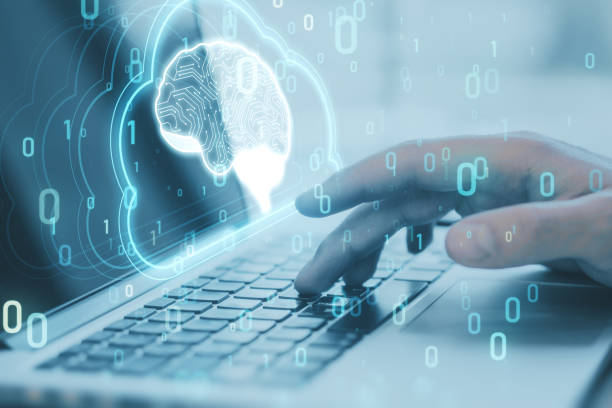 Artificial Intelligence hardware concept. Close up of male hand using laptop with glowing cloud brain and circuit on background. Ai trading, machine learning, technology background. Double exposure. stock photo