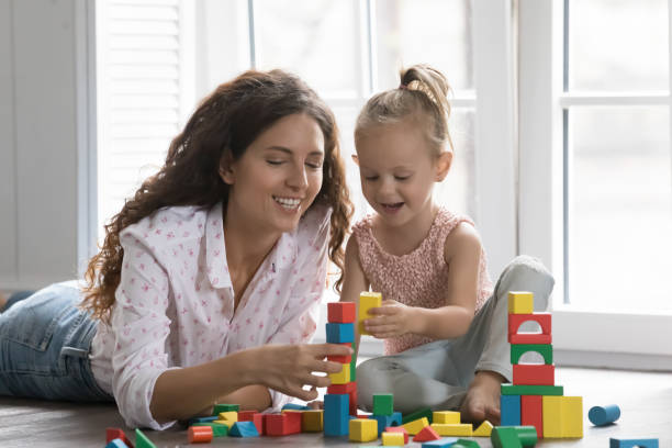 istock Happy mom and kid girl playing on heating floor 1481721936