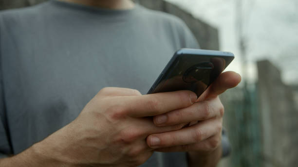 istock Close-Up Shot of Male Hands Using Smartphone Outdoors - Technology and Connectivity Concept 1481738834