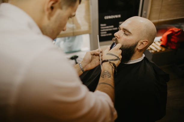 istock A man trims his beard at the barber's 1481738836