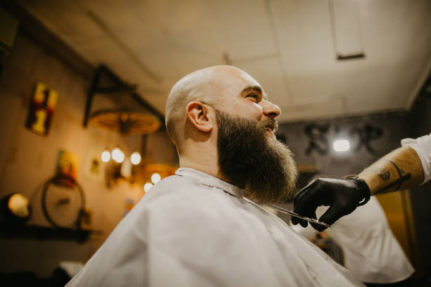istock A man trims his beard at the barber's 1481739267