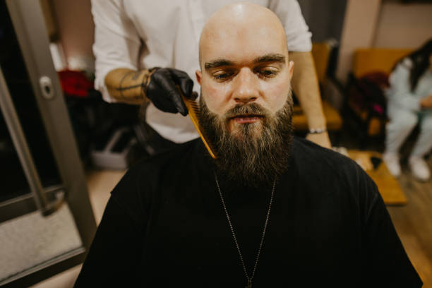 istock A man trims his beard at the barber's 1481739329