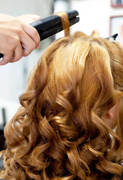 istock Beautiful light, wavy curls, hairstyle closeup. Curling iron, professional 1481740205
