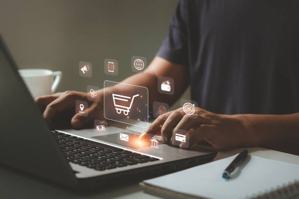 istock Online shopping and e-commerce concept. Young man using laptop computer with shopping cart icon, order in online store, shopping on internet, concept on virtual screen with hands typing on keyboard. 1481740751