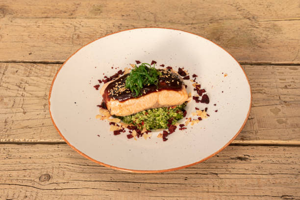 istock Grilled salmon taco garnished with guacamole and beetroot chips 1481742575