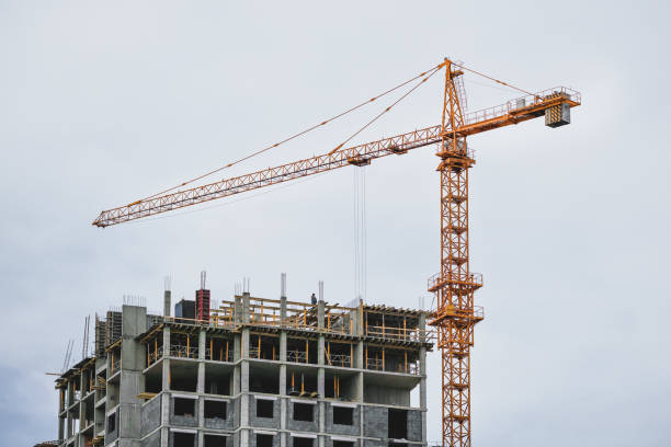 istock High building yellow crane working on construction site near unfinished house 1481743135