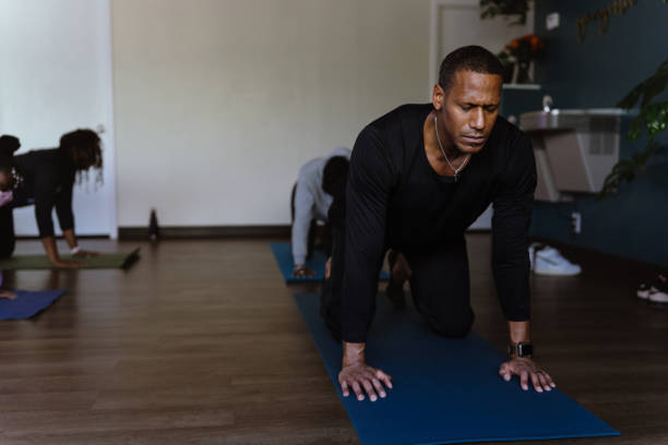 istock Man attending group fitness yoga class 1481746626