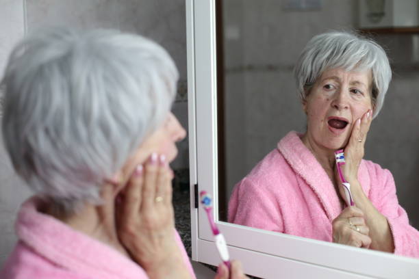 istock Senior woman experimenting pain while washing her teeth 1481748496