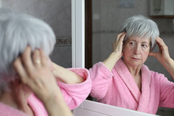 istock Preoccupied looking senior woman in the bathroom mirror 1481749810