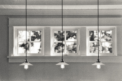 Rustic country cottage with Edison bulb light fixtures and  sunlight dappling through windows