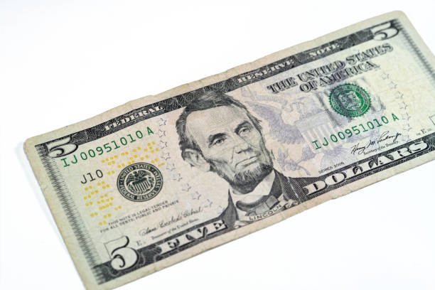 istock Obverse side of a torn 5 five dollars bill banknote repaired with adhesive plaster with the portrait of president Abraham Lincoln, old American money banknote, vintage retro, United States of America 1481754172