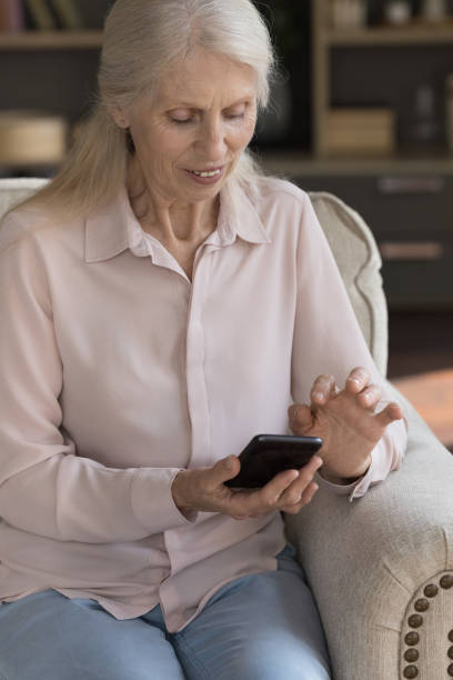istock Positive elder woman typing on mobile phone, using online app 1481755899
