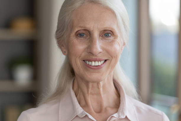 istock Happy senior lady looking at camera with toothy smile 1481755912