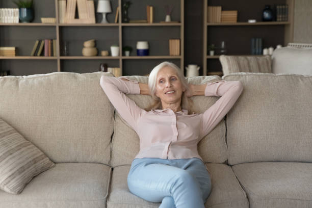 istock Thoughtful positive old senior woman resting on comfortable sofa 1481755913