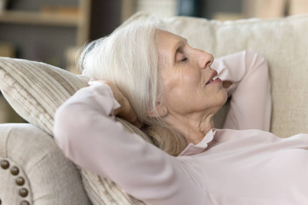 istock Relaxed sleepy older woman resting on comfortable couch 1481755914