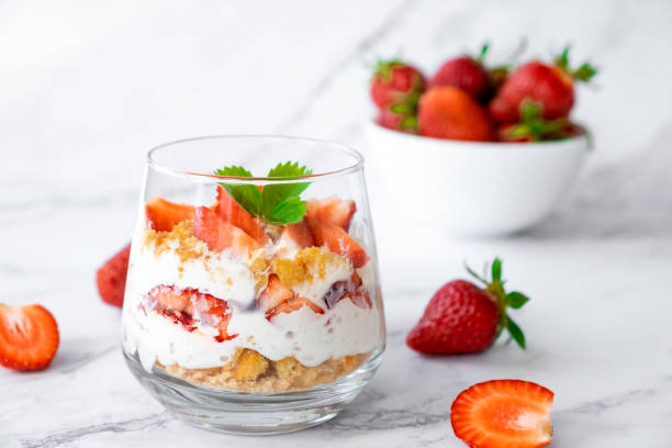 Strawberry dessert Strawberry trifle dessert with custard, cake crumb and fresh strawberry in glass on marble. Recipe of simple layered dessert with fresh berry and jam. Lactose free cheesecake, vegan dessert tiramisu. trifle stock pictures, royalty-free photos & images