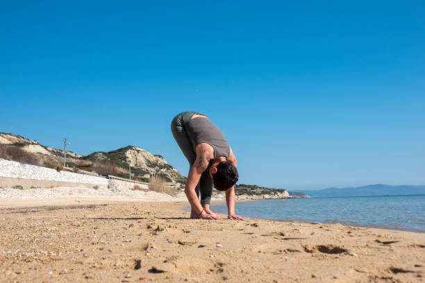 istock Woman practising yoga on the beach 1481758524