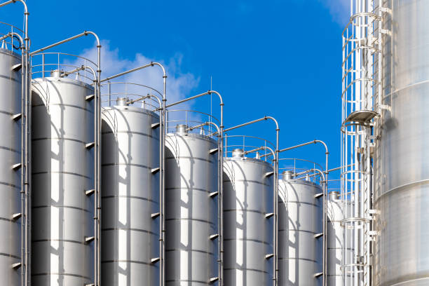 silos de acero inoxidable contra el cielo azul. - storage tank silo chemical factory fotografías e imágenes de stock