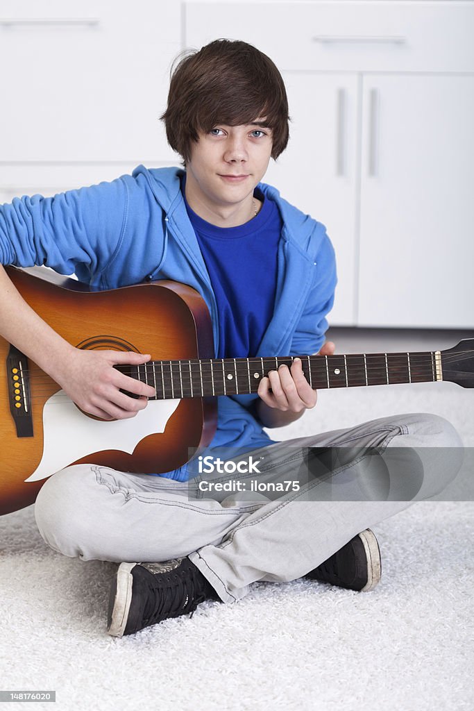 Young teenager boy playing the guitar Young teenager boy playing the acoustic guitar Acoustic Guitar Stock Photo