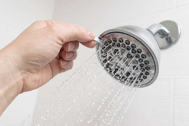 Shower head adjustment stock photo