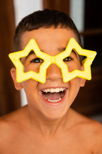 Portrait of a child wearing funny glasses and smiling