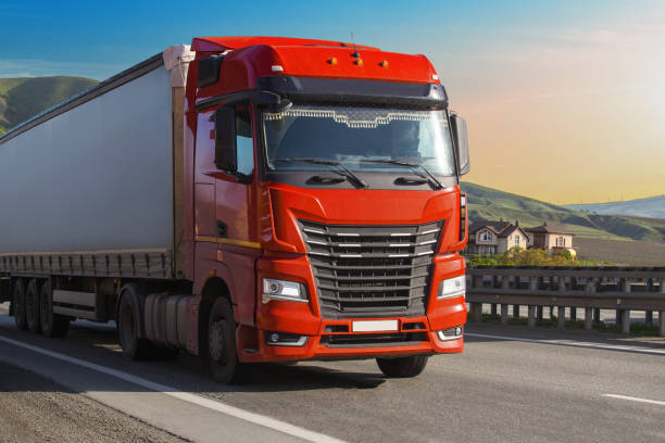 istock Truck driving on a suburban highway 1481763705