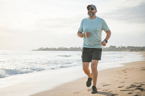 istock man walking and doing sports on the beach 1481763846