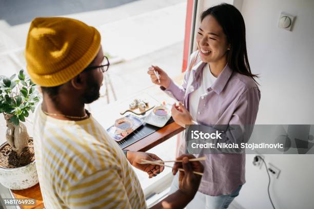 Couple Eating Sushi Stock Photo - Download Image Now - Business Lunch, Chopsticks, Couple - Relationship