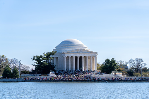 Washington D.C. - March 26 2023: The Jefferson Memorial Seen on a Busy Spring Day with Many People Sitting on the Steps