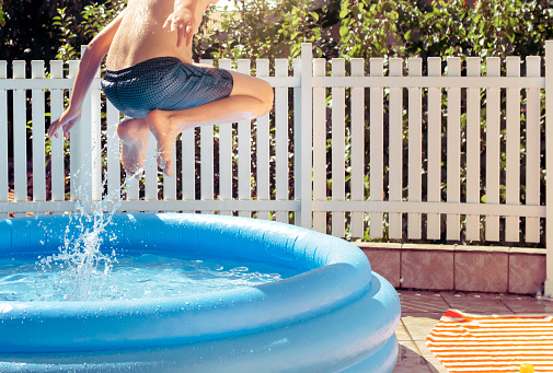 Child having fun in rubber swimming pool