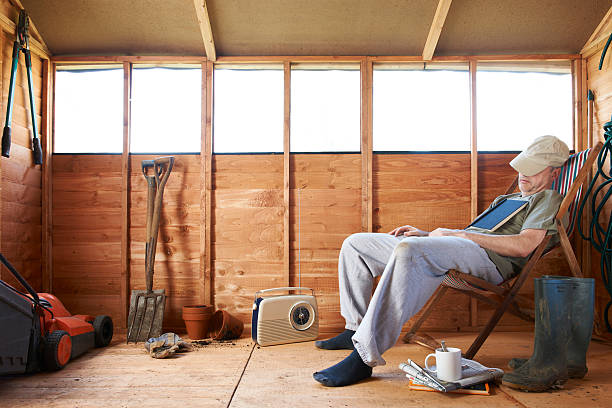 Asleep in shed Man sitting in deckchair falling asleep in the shed man sleeping chair stock pictures, royalty-free photos & images