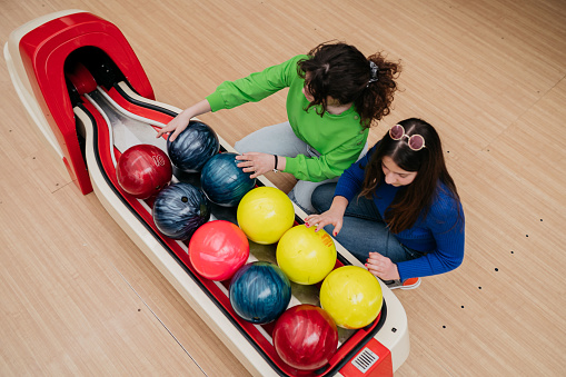 Friends With Multicolored Bowling Balls