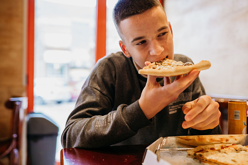 Teenage boy enjoying pizza